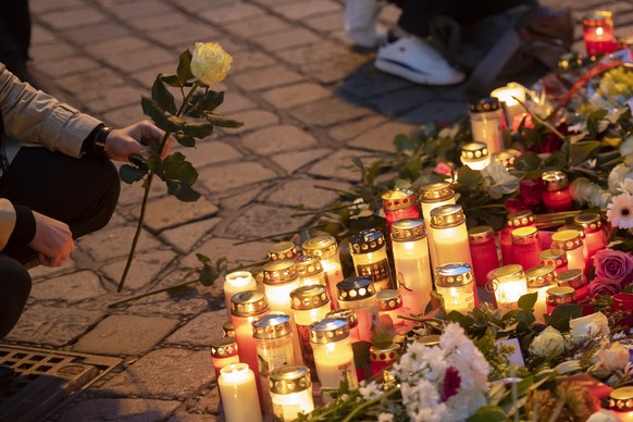 epa08798712 A man places a flower at the crime scene of multiple shootings in the first district of Vienna, Austria, 04 November 2020. According to recent reports, at least four persons are reported t ...