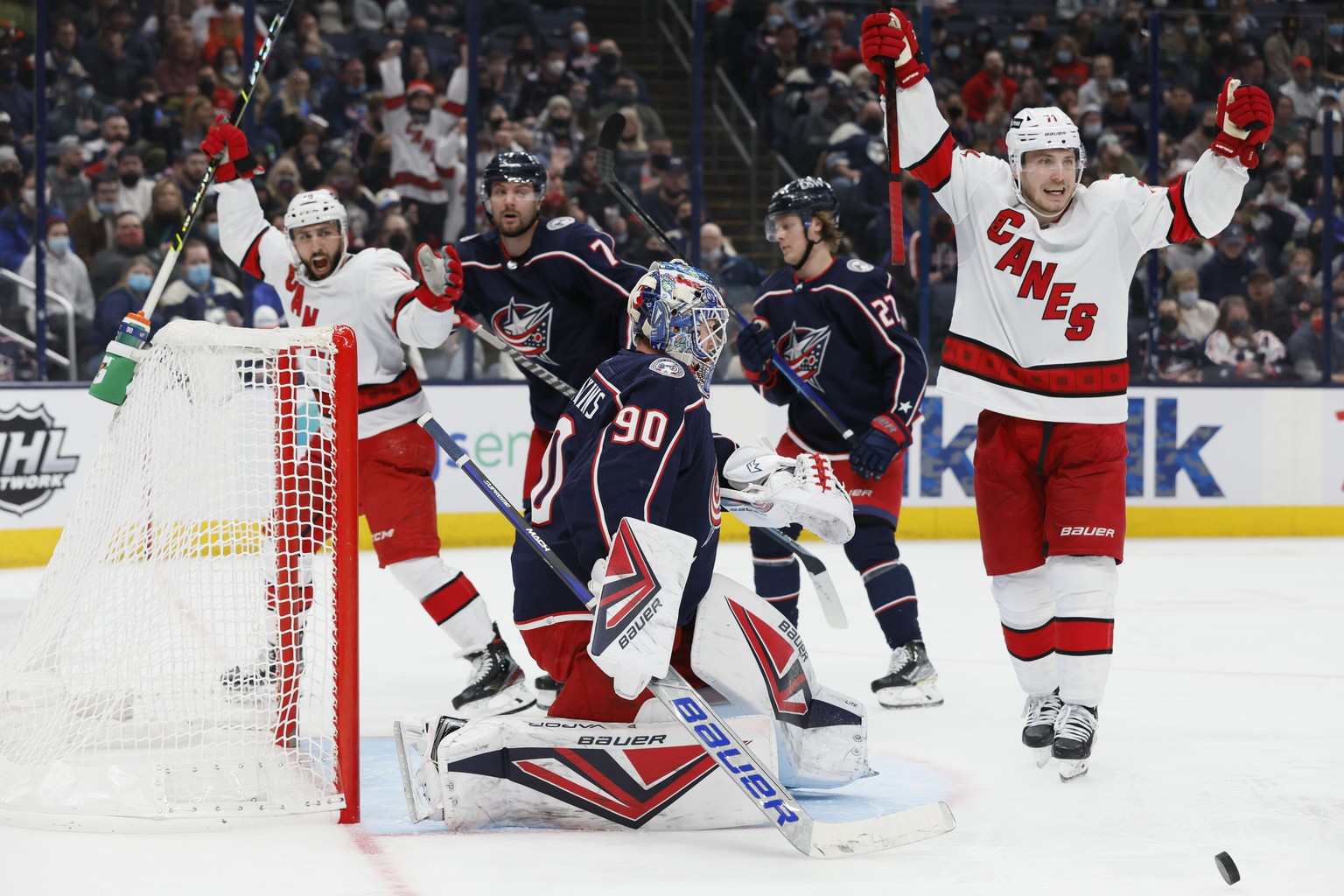 Carolina Hurricanes&#039; Vincent Trocheck, left, and Jesper Fast, right, celebrate their goal against the Columbus Blue Jackets during the third period of an NHL hockey game Saturday, Jan. 1, 2022, i ...