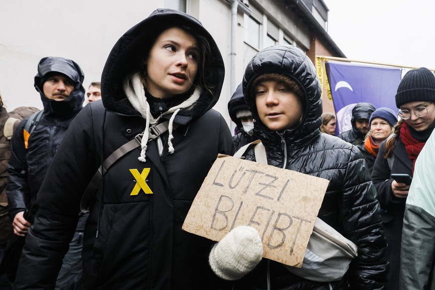 epaselect epa10404615 Swedish climate activist Greta Thunberg (R) holding a placard reading &#039; Luetzi stays&#039; is joined by German climate activist Luisa Neubauer (L) as they attend a rally of  ...