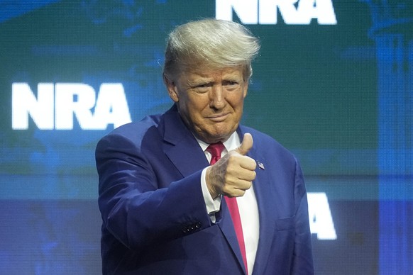 Former President Donald Trump reacts to the crowd before speaking during the National Rifle Association Convention, Friday, April 14, 2023, in Indianapolis.  (AP Photo/Darron Cummings)