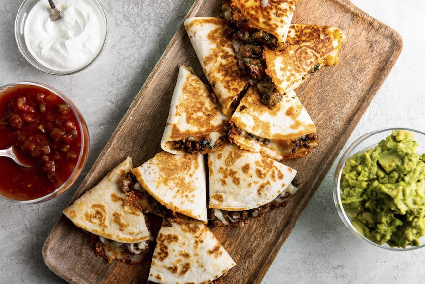 This image shows a recipe for cheesy ground beef quesadillas. More people are cooking at home these days, and when they do eat restaurant food, they���re often looking for comfort food, experts say. O ...