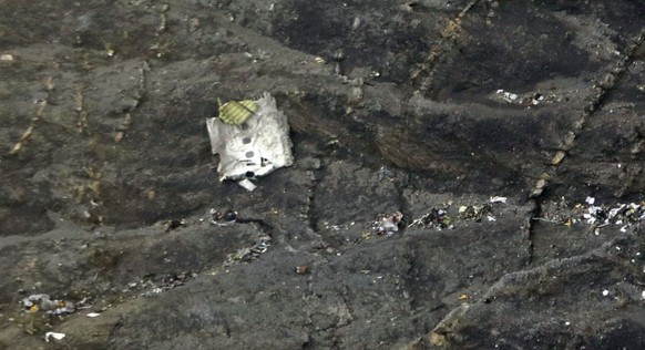 epa04677849 A handout photo made available by the German Foreign Office on 25 March 2015 of a piece of wreckage and debris on the mountain slopes after the crash of the Germanwings Airbus A320 over th ...