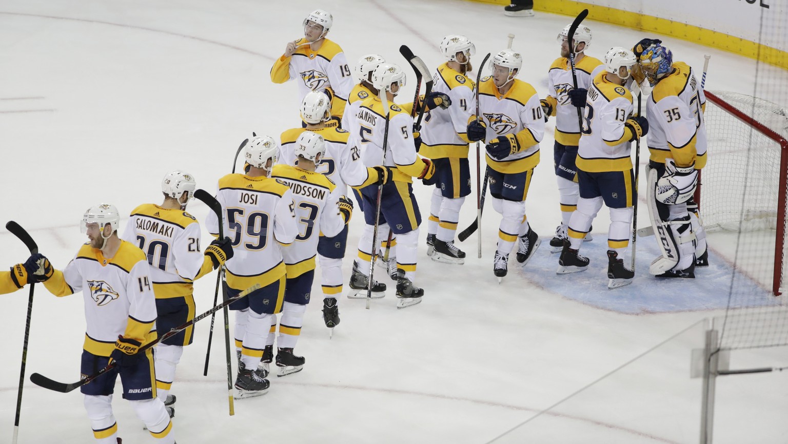 Nashville Predators goaltender Pekka Rinne (35) celebrates with teammates after an NHL hockey game against the New York Rangers on Thursday, Oct. 4, 2018, in New York. The Predators won 3-2. (AP Photo ...