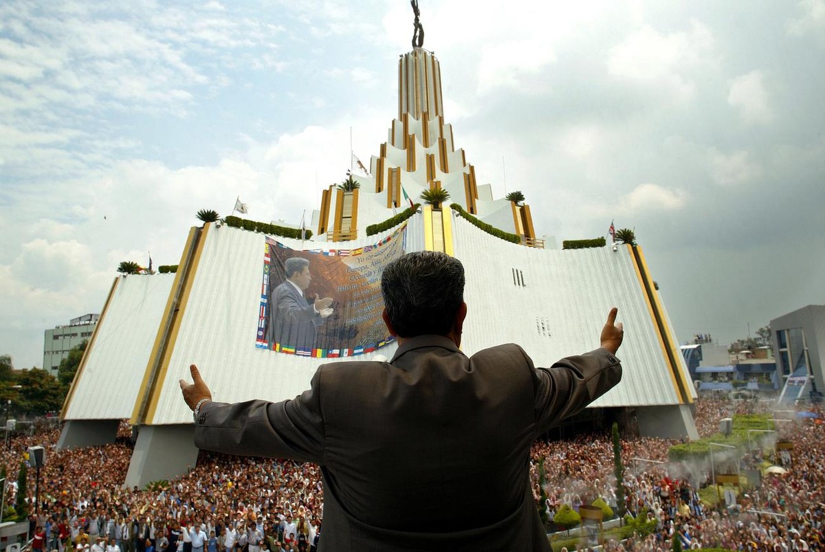 A Light of the World Church leader, Samuel Joaquin Flores, greets people from his balcony during the 'Holy Convocation' of the Light of the World Church at La Hermosa Provincia, Thursday, Au ...