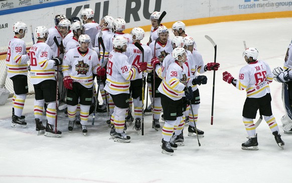 Kunlun Red Star&#039;s team players celebrate after they won the Kontinental Hockey League match against Spartak Moscow, in Moscow, Russia, Saturday, Oct. 1, 2016. (AP Photo/Pavel Golovkin)