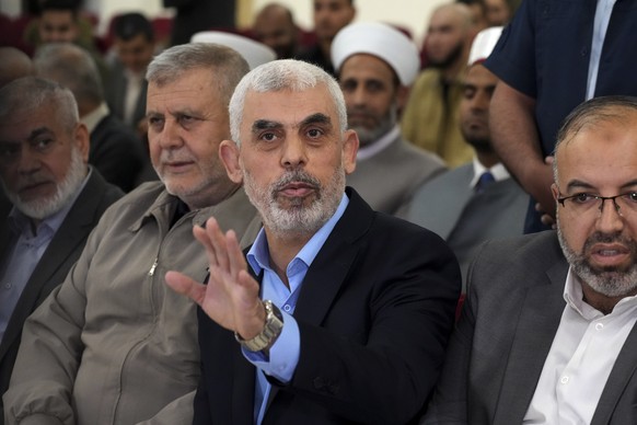 FILE - Yahya Sinwar, head of Hamas in Gaza, greets his supporters upon his arrival at a meeting in a hall on the sea side of Gaza City, on April 30, 2022. Since Hamas fighters carried out the deadlies ...