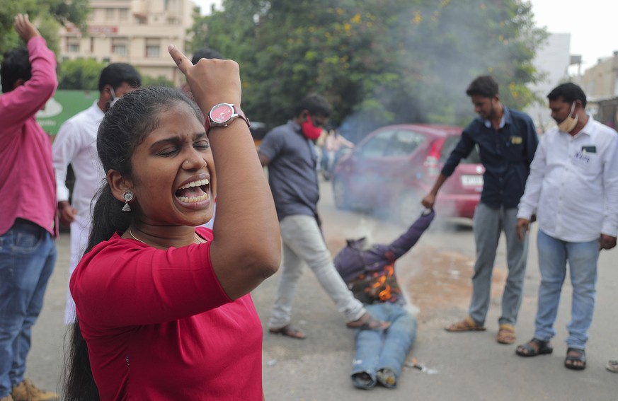 Student activists shout slogans while burning an effigy of Uttar Pradesh state Chief Minister Yogi Adityanath during a protest against the gang rape and killing of a teenager, in Hyderabad, India, Thu ...