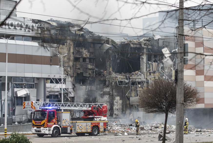 epa11047815 Emergency services work at the site of an overnight rocket attack on a shopping mall in Dnipro, Dnipropetrovsk region, southeastern Ukraine, 29 December 2023, amid the Russian invasion. At ...