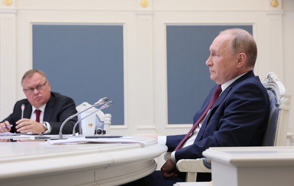 epa09612556 Russian President Vladimir Putin (R) and VTB bank President Andrey Kostin (L) attend a session of the annual VTB Capital &#039;Russia Calling&#039; Investment Forum via a video conference  ...
