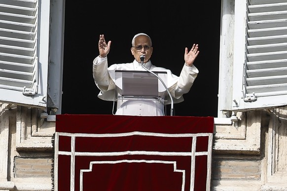 epa12607072 Pope Leo XIV leads the Angelus prayer, the traditional Sunday prayer, from the window of his office overlooking Saint Peter's Square, Vatican City, 21 December 2025. EPA/ANGELO CARCON ...
