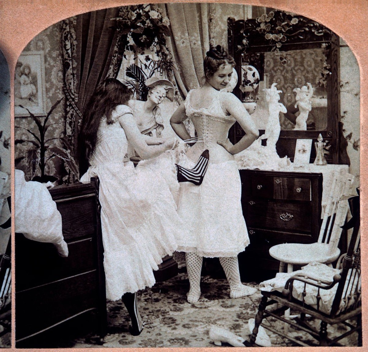 Young Woman Lacing Up Another Woman's Corset, Single Image of Stereo Card, 1897. (Photo by: Universal History Archive/Universal Images Group via Getty Images)