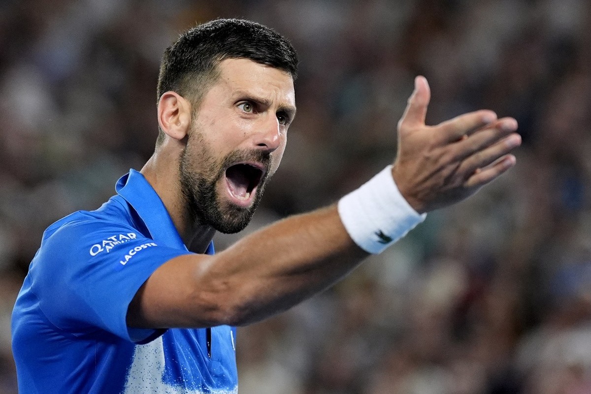 Novak Djokovic of Serbia reacts during his quarterfinal match against Carlos Alcaraz of Spain at the Australian Open tennis championship in Melbourne, Australia, Tuesday, Jan. 21, 2025. (AP Photo/Asan ...