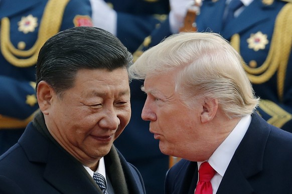 FILE - President Donald Trump, right, talks with China&#039;s President Xi Jinping during a welcome ceremony at the Great Hall of the People in Beijing, Nov. 9, 2017. (AP Photo/Andy Wong, File)
Donald ...
