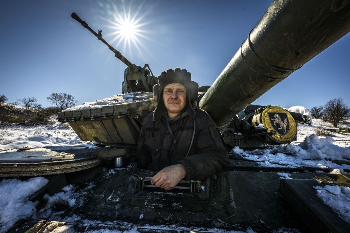 DONETSK OBLAST, UKRAINE - MARCH 31: A Ukrainian soldier is on the snow covered tank amid Russia-Ukraine war in Donetsk Oblast, Ukraine on March 31, 2023. Military aid is provided by a framework of &qu ...