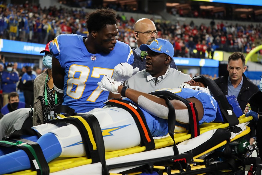 epa09645958 Los Angeles Chargers tight end Jared Cook (L) walks alongside Los Angeles Chargers tight end Donald Parham as he is carried out on a stretcher after an injury during the first half of the  ...