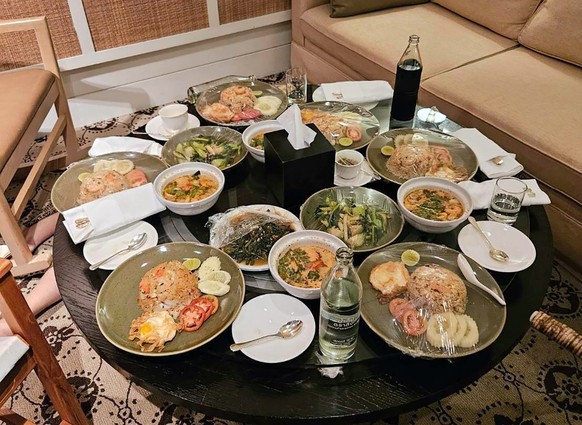 epa11483010 A handout photo made available by the Royal Thai Police shows food on a table inside a hotel room where six people were found dead of poisoning at Grand Hyatt Erawan Hotel in Bangkok, Thai ...