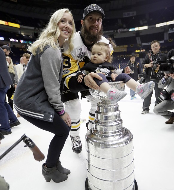 Pittsburgh Penguins&#039; Nick Bonino celebrates with the Stanley Cup with his 17-month-old daughter Maisie and wife Lauren after defeating the Nashville Predators 2-0 in Game 6 of the NHL hockey Stan ...