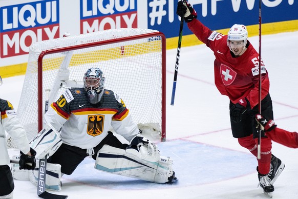 Switzerland&#039;s Dario Simion, right, celebrates the goal to 3-2 against Germany&#039;s goalkeeper Philipp Grubauer during the Ice Hockey World Championship group A preliminary round match between S ...