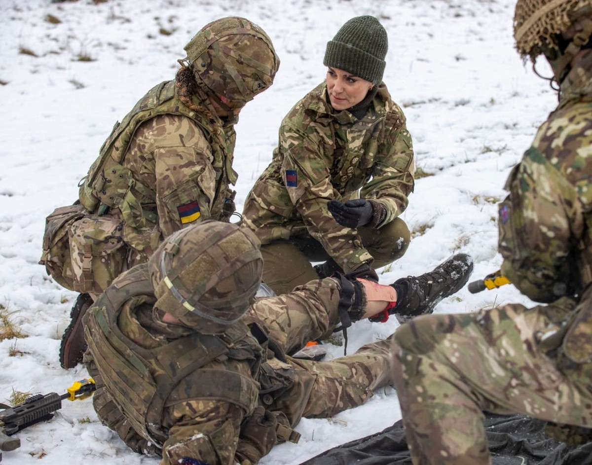 SALISBURY, ENGLAND - MARCH 08: Catherine, Princess of Wales assists L/Cpl Jodie Newell tend to a "wounded soldier" in an exercise, during her visit to the Irish Guards on Salisbury Plain, on ...