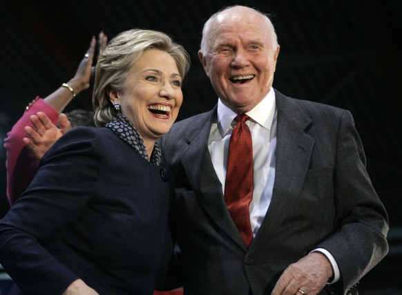 FILE – In this Feb. 14, 2008, file photo, Democratic presidential hopeful U.S. Sen. Hillary Rodham Clinton, D-N.Y., left, reacts as she is introduced by astronaut and former Democratic U.S. Sen. John  ...