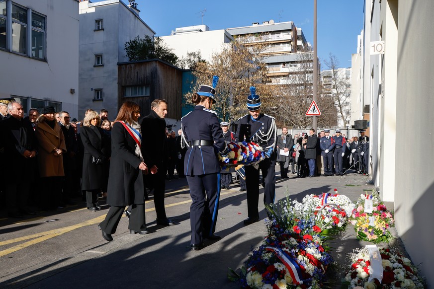 epa11810895 France&#039;s President Emmanuel Macron (C-R) and Mayor of Paris Anne Hidalgo (C-L), flanked by France&#039;s Prime Minister Francois Bayrou (L), take part in the wreath laying ceremony as ...