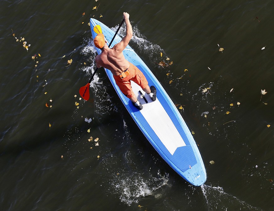 A stand-up-paddler steers his board over the Main river in Frankfurt, Germany, Thursday, Nov. 2, 2017. (AP Photo/Michael Probst)