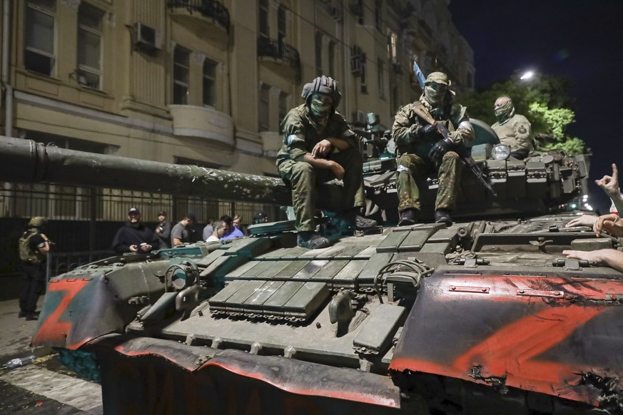 FILE - Membes of the Wagner Group military company sit atop of a tank on a street in Rostov-on-Don, Russia, Saturday, June 24, 2023, prior to leaving an area at the headquarters of the Southern Milita ...