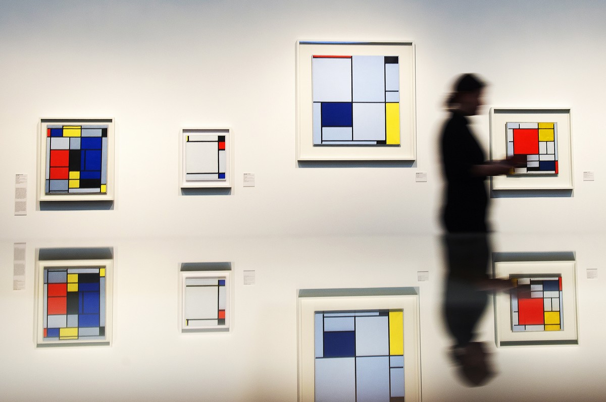 In this picture taken with a long time exposure a visitor is reflected in a showcase in front of works by Piet Mondrian during the press preview of the exhibition 'Visionary Spaces. Kandinsky, Mo ...