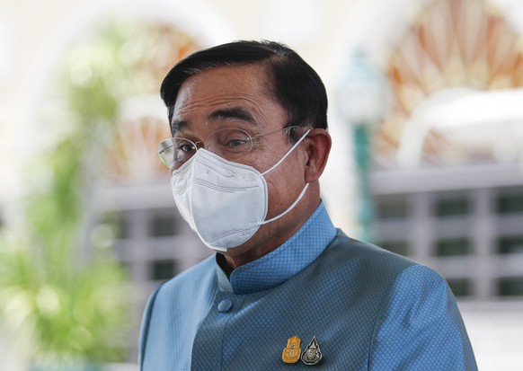 epa10134217 Thai Prime Minister Prayut Chan-o-cha leaves after a weekly cabinet meeting at the Government House in Bangkok, Thailand, 23 August 2022. The prime minister is facing calls to step down by ...