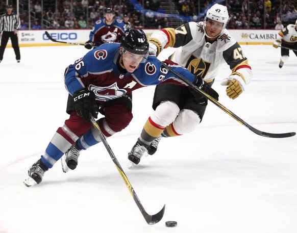 Colorado Avalanche right wing Mikko Rantanen (96) skates past Las Vegas Golden Knights defenseman Luca Sbisa (47) during the third period of a preseason hockey game, Tuesday, Sept. 19, 2017, in Denver ...