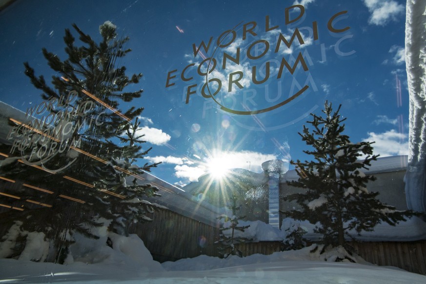 A WEF logo is pictured on a window of the Congress Center in front of snow covered trees two days prior to the 49th Annual Meeting of the World Economic Forum, WEF, in Davos, Switzerland, Sunday, Janu ...