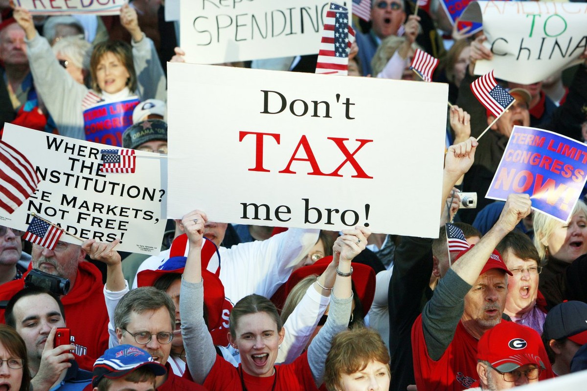 A woman holds a sign that reads "Don't tax me bro! " during the Atlanta Tea Party tax protest Wednesday, April 15, 2009 in Atlanta. Thousands of protesters, some dressed like Revolution ...