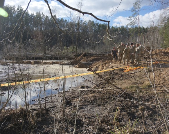 In this image provided by the U.S. Army, U.S. Army soldiers from the 1st Armored Brigade Combat Team, 3rd Infantry Division, along with Lithuanian Army and emergency services personnel, discuss their  ...