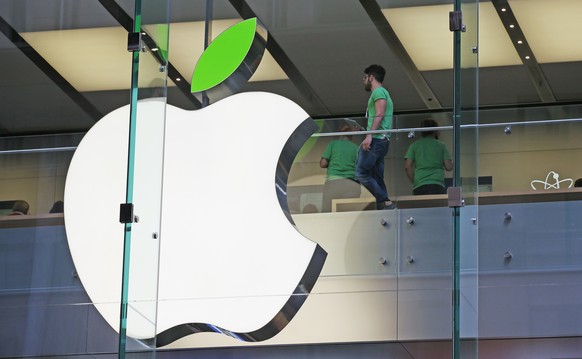 Employees wear green shirts near Apple&#039;s familiar logo displayed with a green leaf at the Apple Store timed to coincide with Tuesday&#039;s annual celebration of Earth Day in Sydney, Tuesday, Apr ...