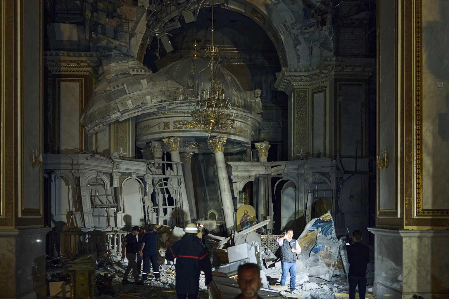 People walk inside the Odesa Transfiguration Cathedral, heavily damaged in a Russian missile attack in Odesa, Ukraine, Sunday, July 23, 2023. (AP Photo/Libkos)