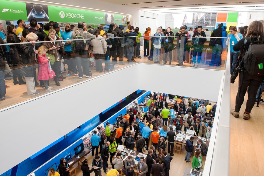 NEW YORK, NY - OCTOBER 26: Customers look at merchandise at Microsoft&#039;s first flagship store on Fifth Avenue on October 26, 2015 in New York City. Hundreds of eager customers waited outside to ce ...