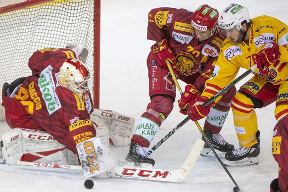 Tigers Goalie Damiano Ciaccio, Yannick Blaser, Mitte, kaempfen um den Puck gegen Biels Marc-Antoine Pouliot, rechts, waehrend dem Meisterschaftsspiel der National League zwischen den SCL Tigers und de ...