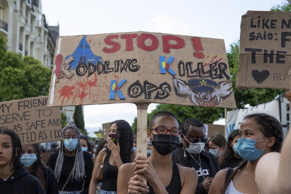 epa08525634 Several thousand demonstrators take part in an anti-racism demonstration, against police violence, during a Black Lives Matter (BLM) protest, in Geneva, Switzerland, 03 July 2020. EPA/SALV ...