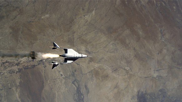 This Saturday, May 22, 2021 image provided by Virgin Galactic shows the release of VSS Unity from VMS Eve and ignition of rocket motor over Spaceport America, N.M. Virgin Galactic completed its third  ...