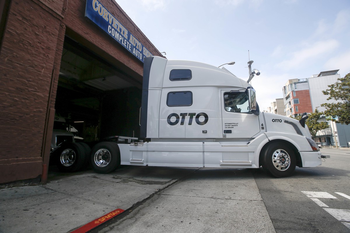 One of Otto's self-driving, big-rig trucks leaves the garage for a test drive during a demonstration at the Otto headquarters on Thursday, Aug. 18, 2016, in San Francisco. Uber announced that it  ...