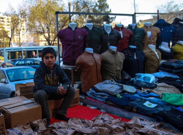 epa09593217 Afghan boys pose for a photograph as the world observes Universal Children&#039;s Day in Kabul, Afghanistan, 20 November 2021. The serious economic crisis in Afghanistan is forcing an incr ...