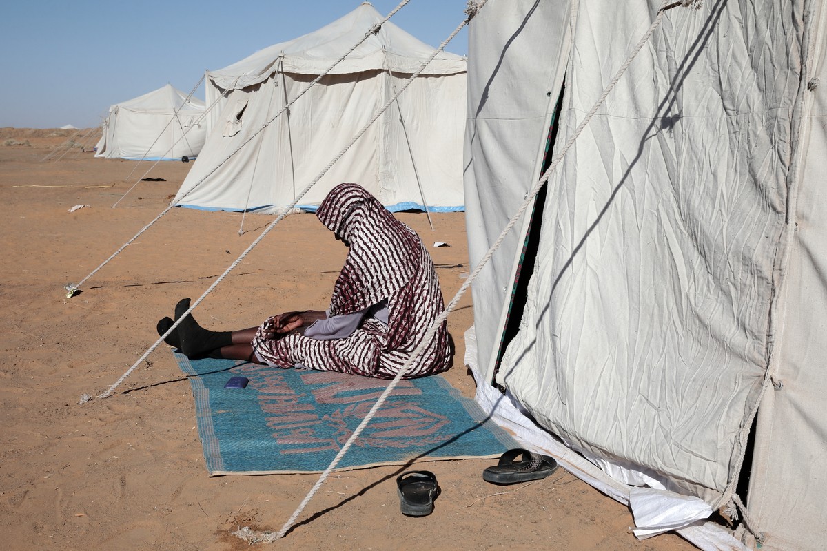 A Sudanese woman displaced from El-Fasher sits outside his tent at the newly established El-Afadh camp in Al Dabbah, in Sudan's Northern State, Sunday, Nov. 16, 2025. (AP Photo/Marwan Ali)
Sudan