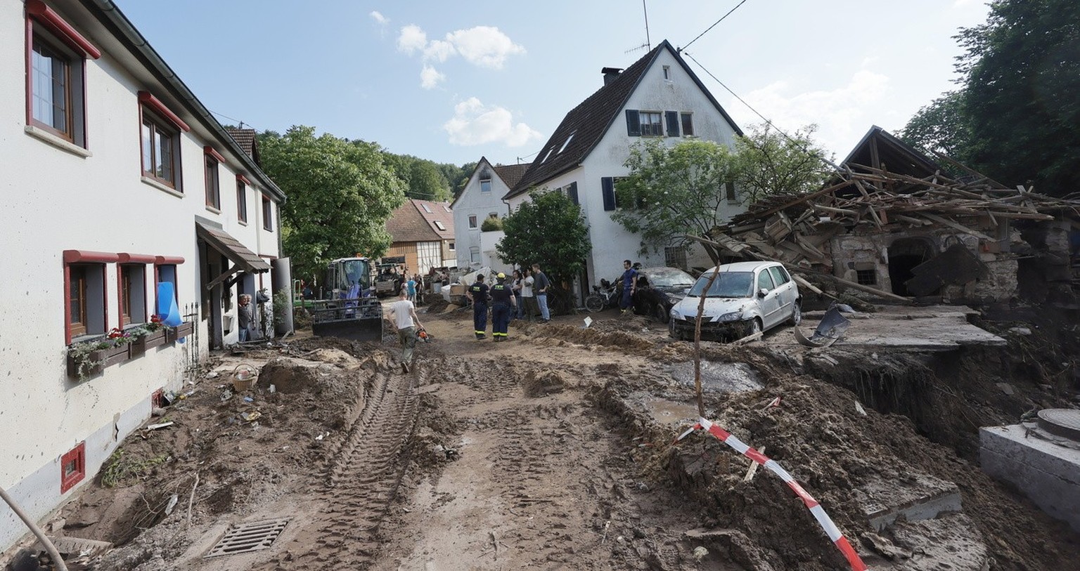 epa11389394 People stand at a flood-damaged part of Klaffenbach near Rudersberg, Germany, 04 June 2024. At least five people have died since heavy rains caused flooding in Germany&#039;s southern stat ...
