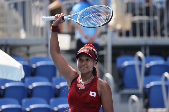 epa09363398 Naomi Osaka of Japan reacts after defeating Saisai Zheng of China in a Women&#039;s Singles First Round match during the Tennis events of the Tokyo 2020 Olympic Games at the Ariake Coliseu ...