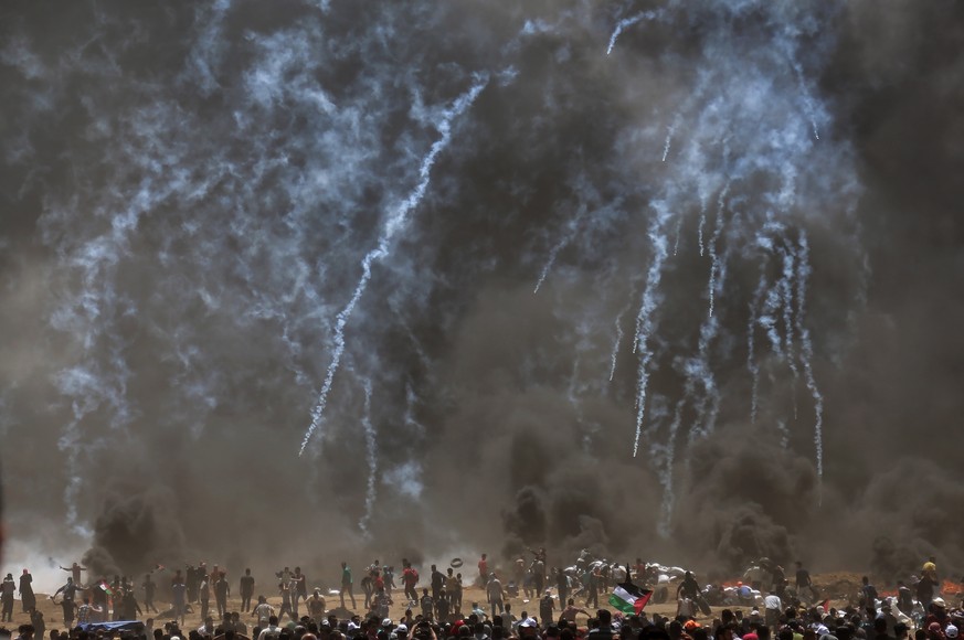 epaselect epa06736870 Israeli troops fire tear-gas at Palestinian protesters during clashes after protests near the border with Israel in the east of Jabaliya in the northern Gaza Strip, 14 May 2018.  ...