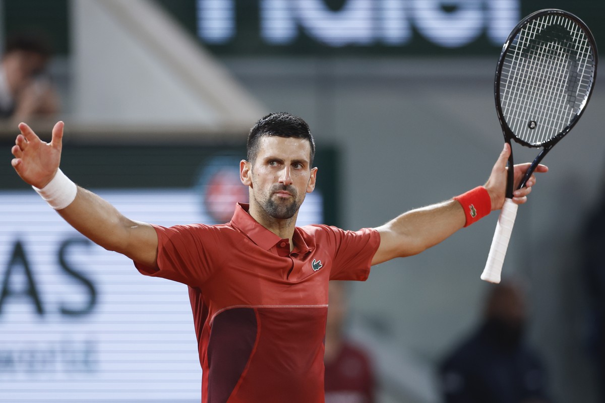 Serbia's Novak Djokovic celebrates winning his third round match of the French Open tennis tournament against Italy's Lorenzo Musetti at the Roland Garros stadium in Paris, Sunday, June 2, 2 ...