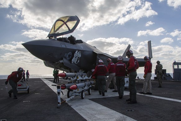 Marine Wing Fighter Attack Squadron (VMFA) 314 personnel refuel and load an F-35C Lightning II with the AIM-120 advanced medium-range air-to-air missile as VMFA-314 performs simulated offensive and de ...