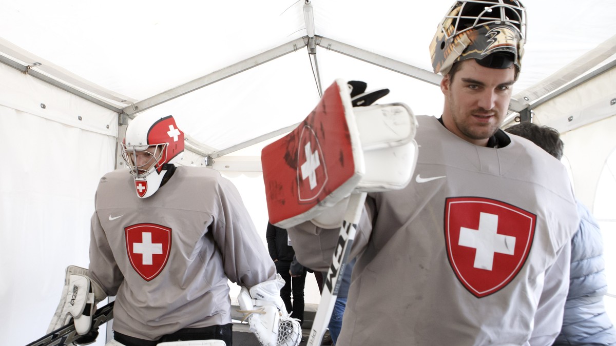 Switzerland's goaltender Leonardo Genoni, left, and Switzerland's goaltender Reto Berra, return to cloakroom, after a training session of the IIHF 2018 World Championship at the practice are ...