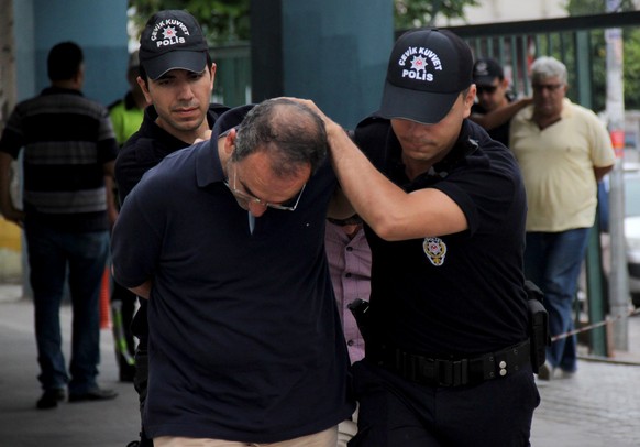 epa05431942 Turkish police with an arrested Turkish soldier at police headquarter in Mersin, Turkey, 19 July 2016. Turkish Prime Minister Yildirim reportedly said that the Turkish military was involve ...