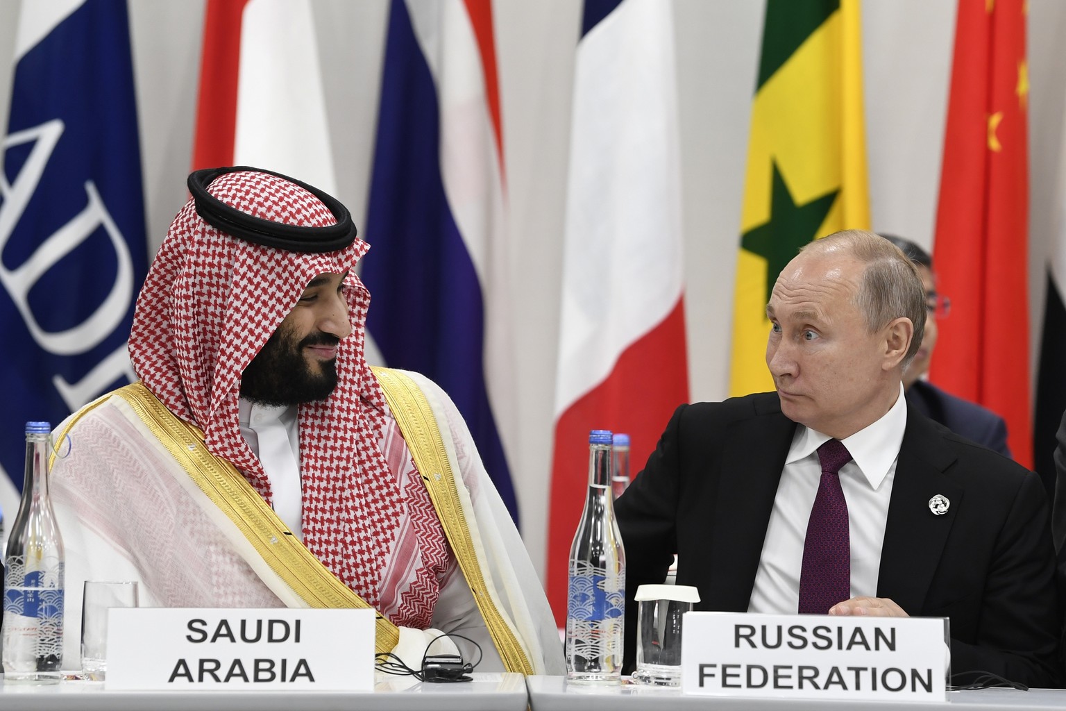 FILE - Crown Prince Mohammed bin Salman of Saudi Arabia, left, talks with Russian President Vladimir Putin, right, during the G-20 Digital Economy Summit in Osaka, Japan, on June 28...